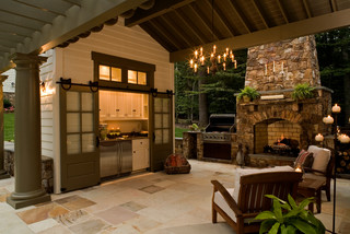 designing outdoor kitchens should address the weather, with doors like this to close